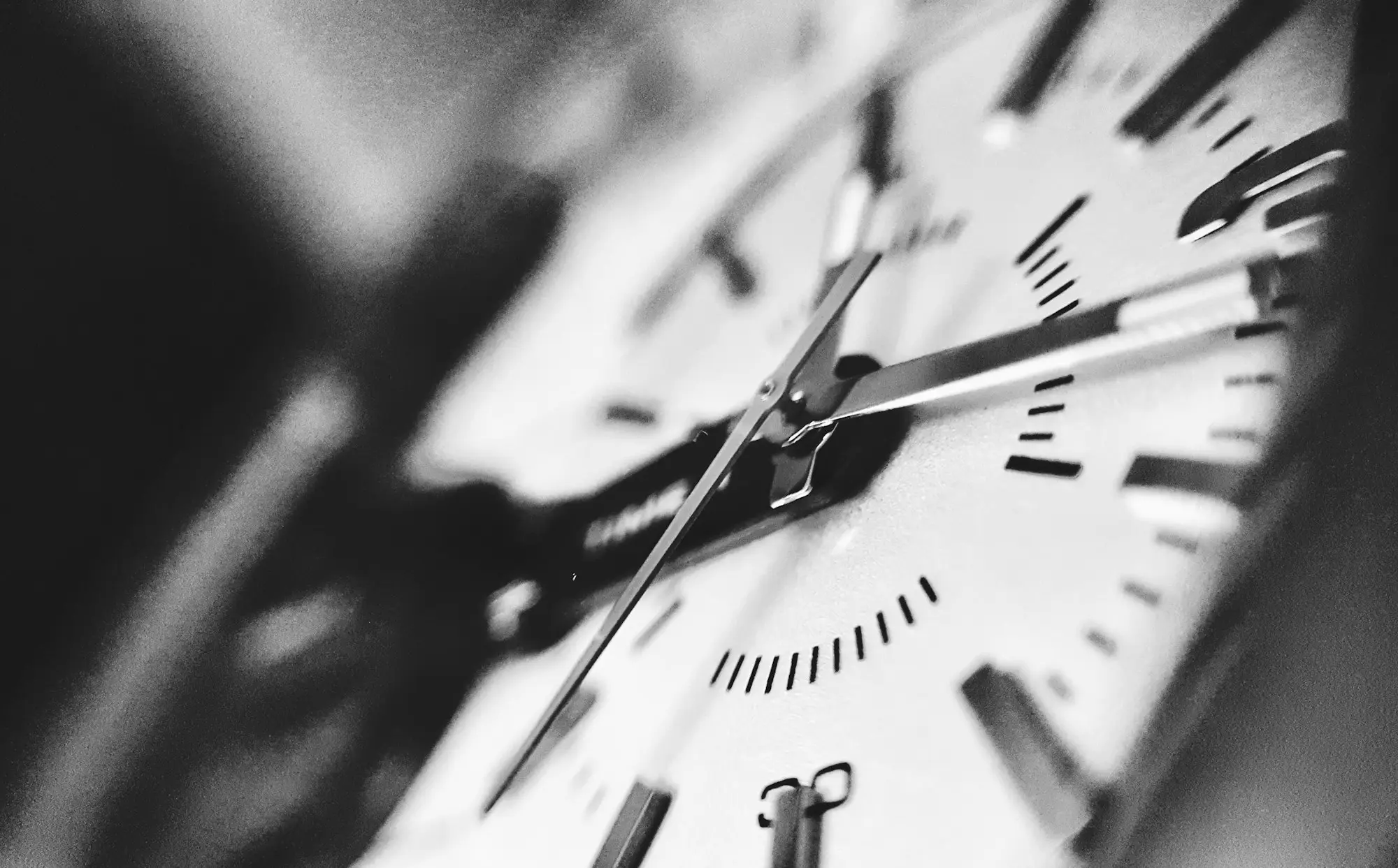 Close-up of a wall clock face in black and white