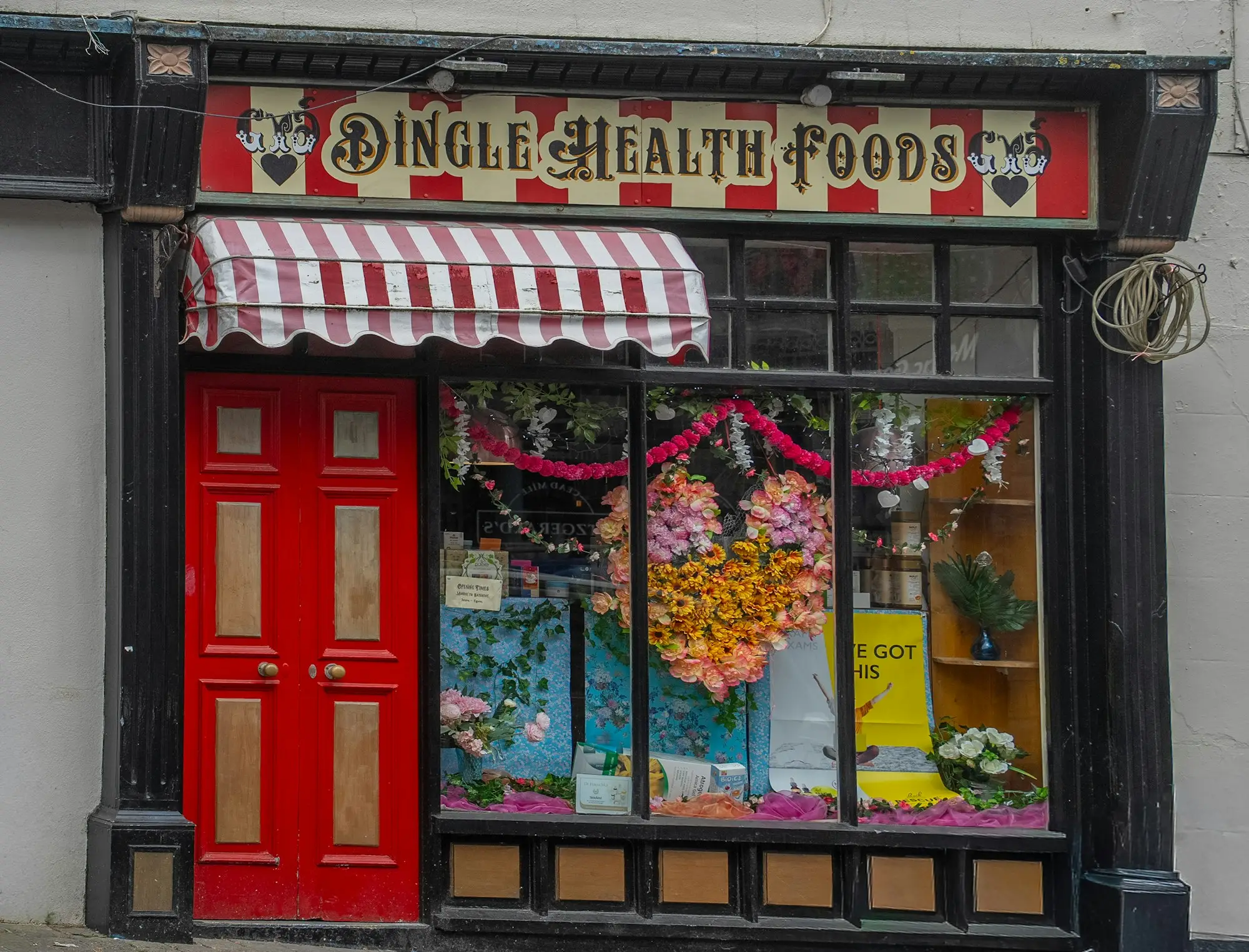 Health food store front with red doors on a city street