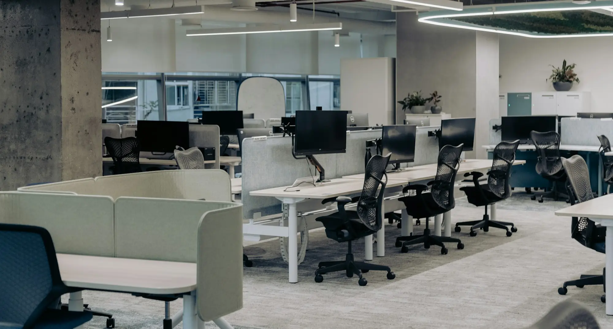 Open-plan office with rows of desks and chairs