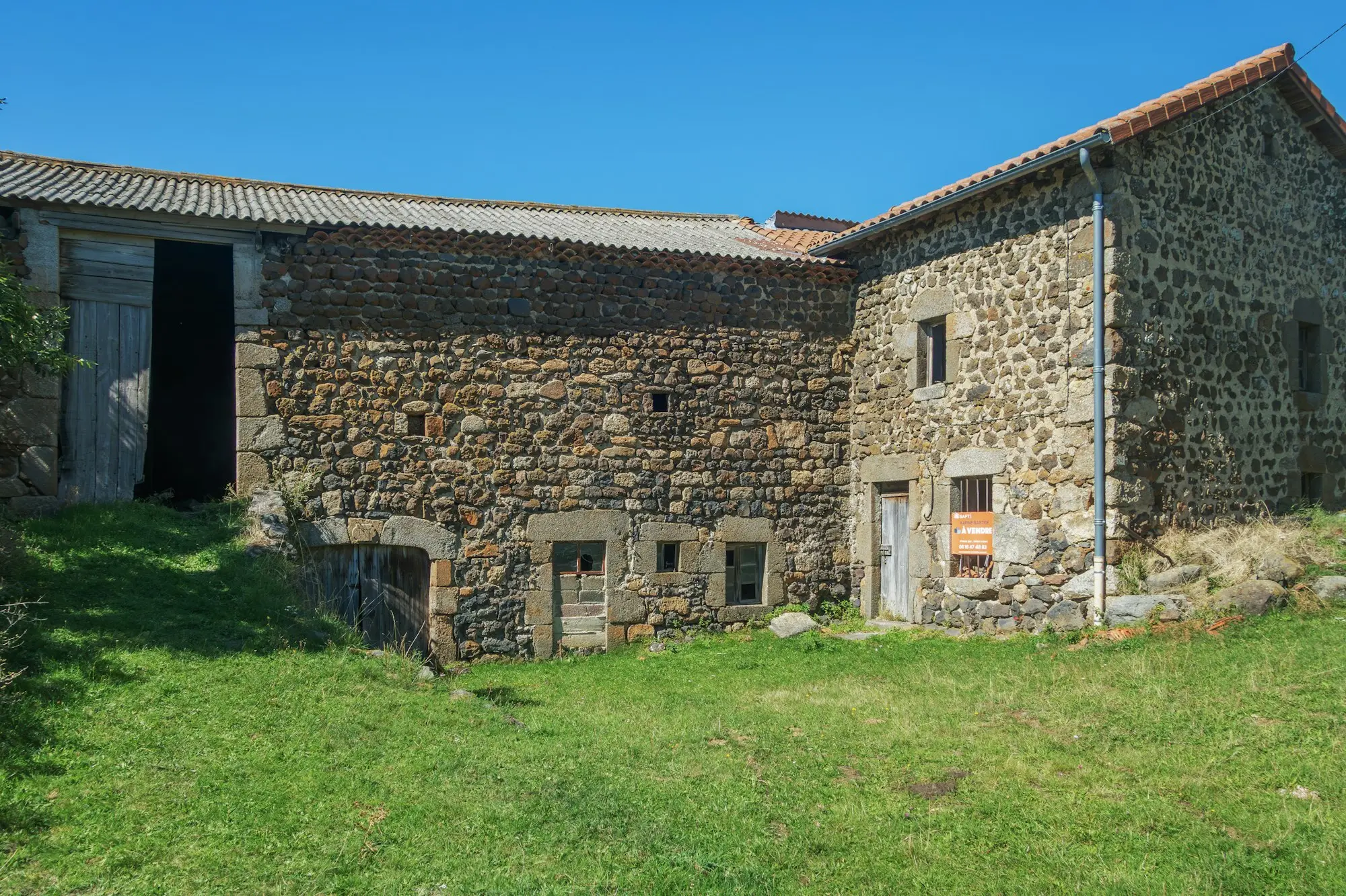 Old stone farmhouse with a grassy yard